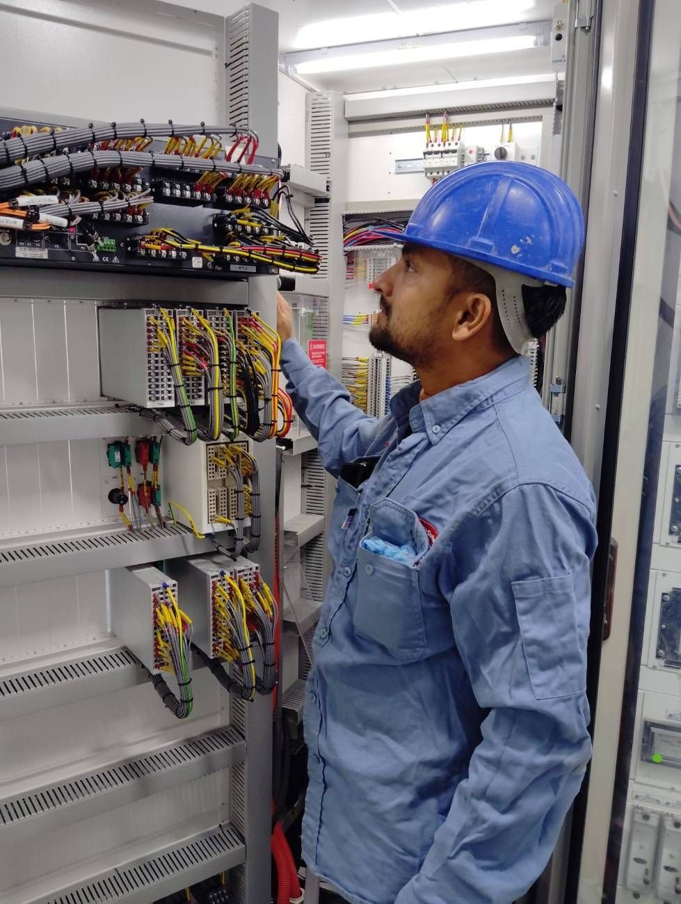 Technician at a control cabinet